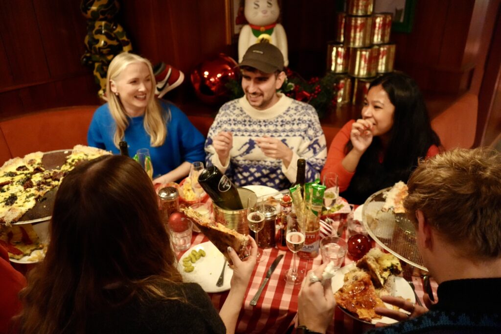 group of people eating pizza at Civerinos Stockbridge