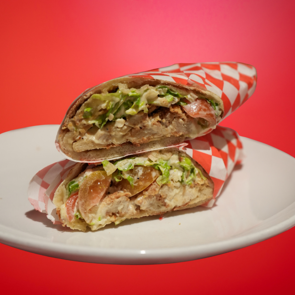 Schnitzel panuozzo on white plate with red background