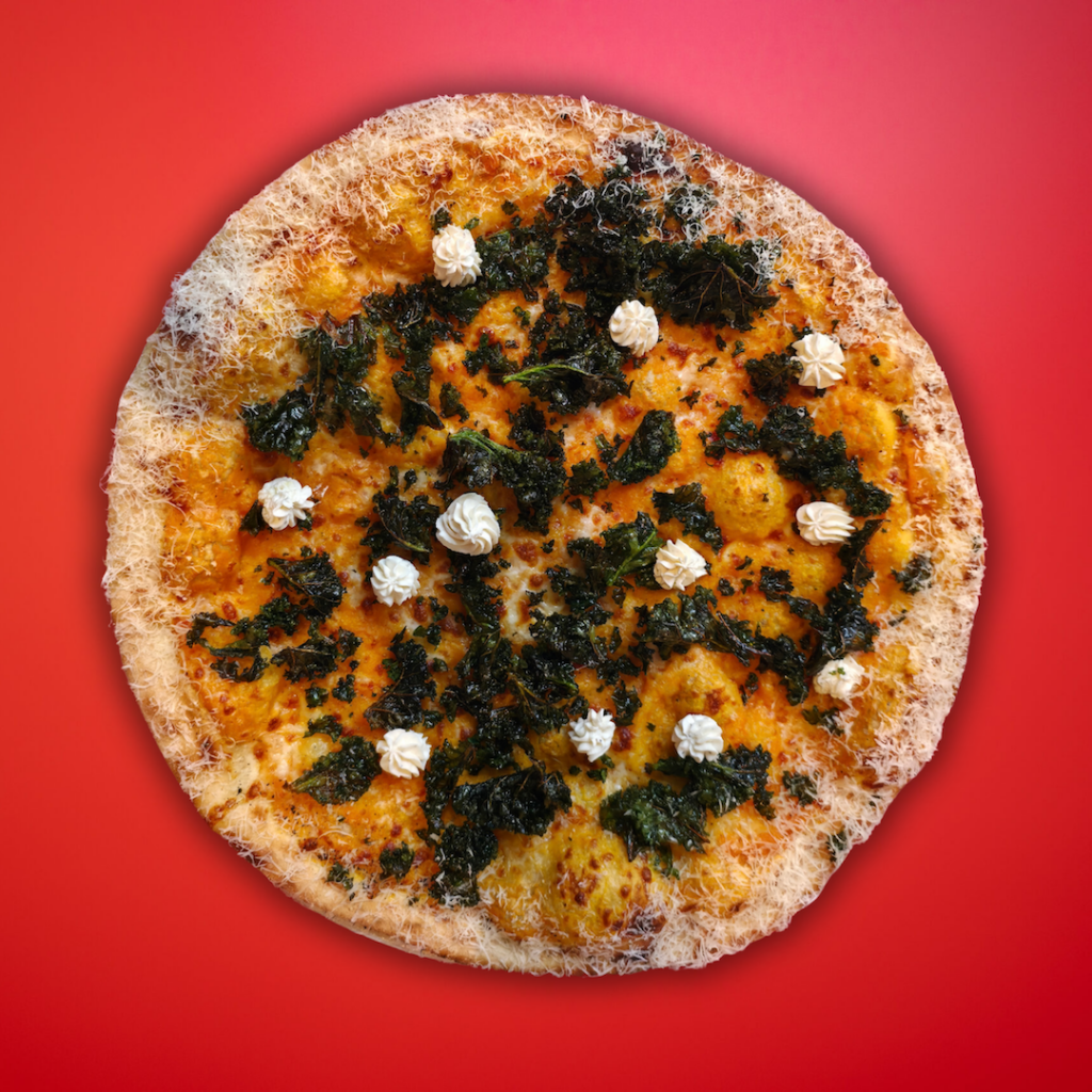 Sweet potato, kale & truffle ricotta New York pizza on red background