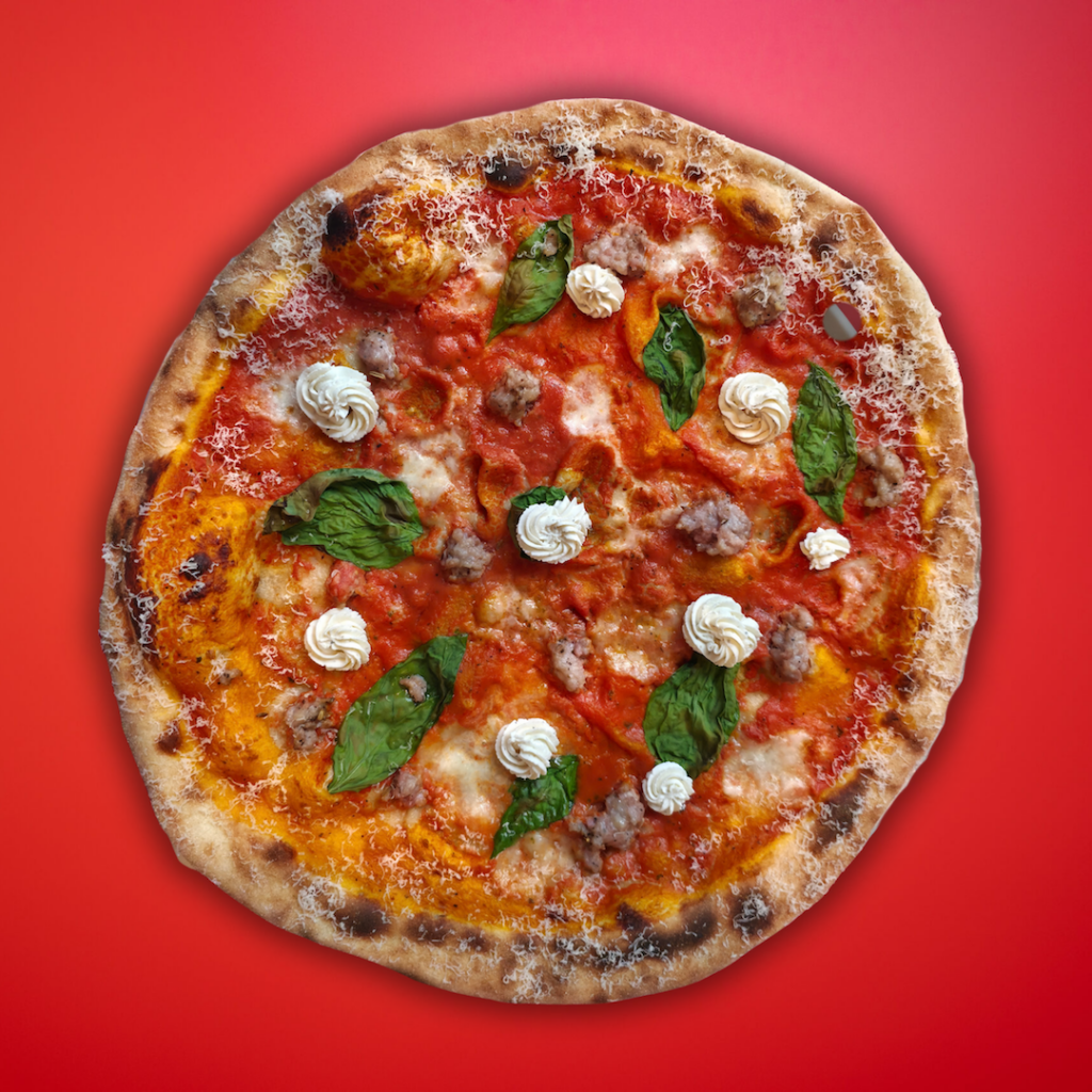 vodka sauce and sausage New York pizza on red background