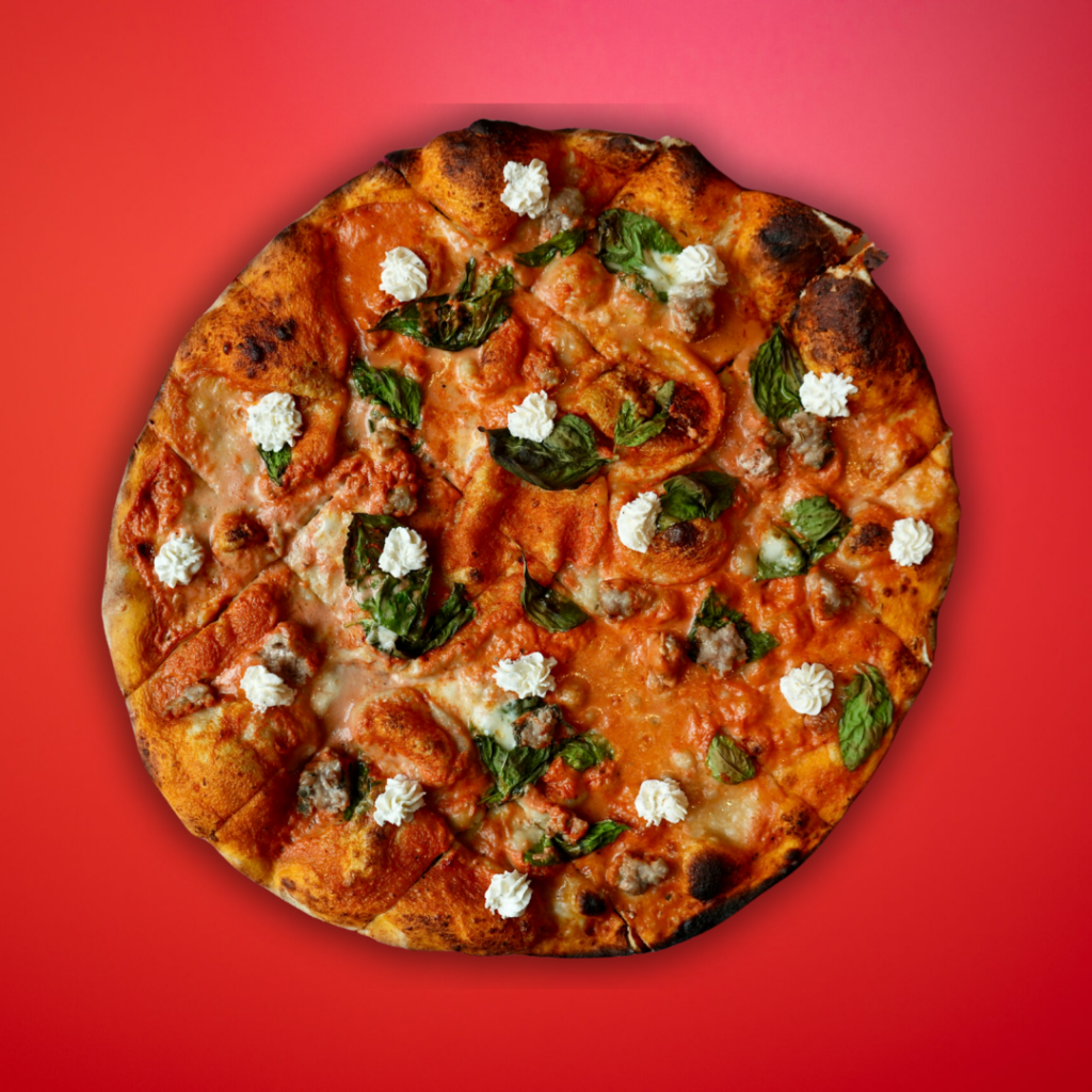 Vodka sauce and sausage New Haven pizza on red background